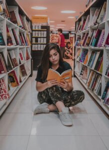 woman sitting on floor while reading